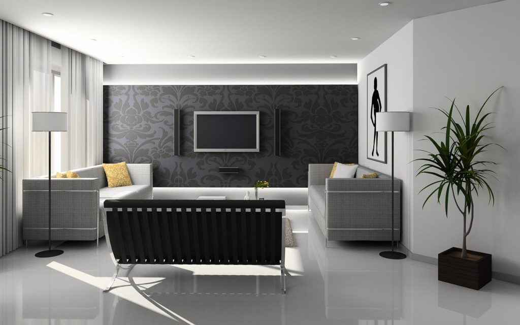 salon moderne minimaliste avec canapé noir, murs gris damassé et tv murale intégrée