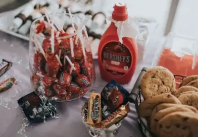 A delightful assortment of candies, chocolates, and cookies on a table, perfect for indulgence.
