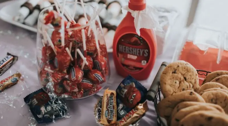 A delightful assortment of candies, chocolates, and cookies on a table, perfect for indulgence.