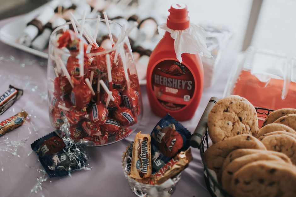 A delightful assortment of candies, chocolates, and cookies on a table, perfect for indulgence.