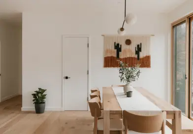 Modern dining room with desert-themed wall hanging.
