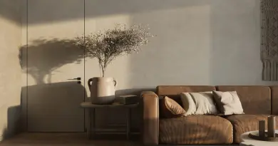 Warm minimalist living room featuring a brown sofa and decorative elements.