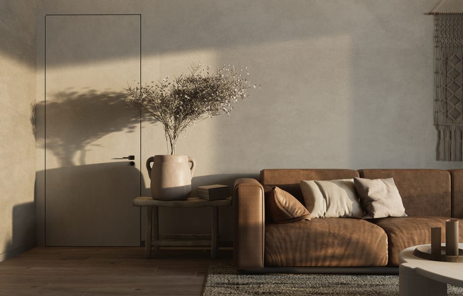 Warm minimalist living room featuring a brown sofa and decorative elements.