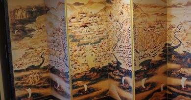 Antique map art is depicted on a folding screen.